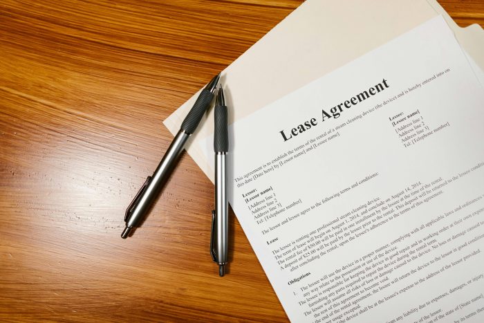 Lease agreement with two pens on a table